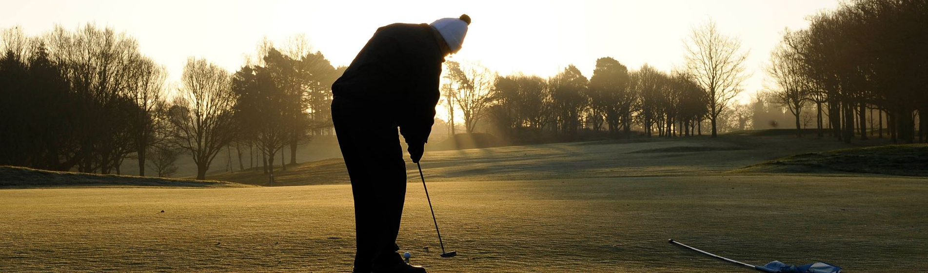 Man putting on golf course